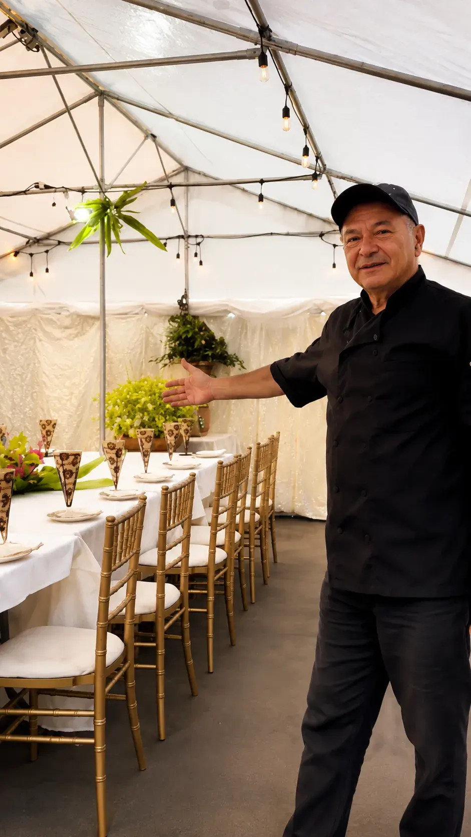 The private garden tent set with gold chairs and white linen for an event